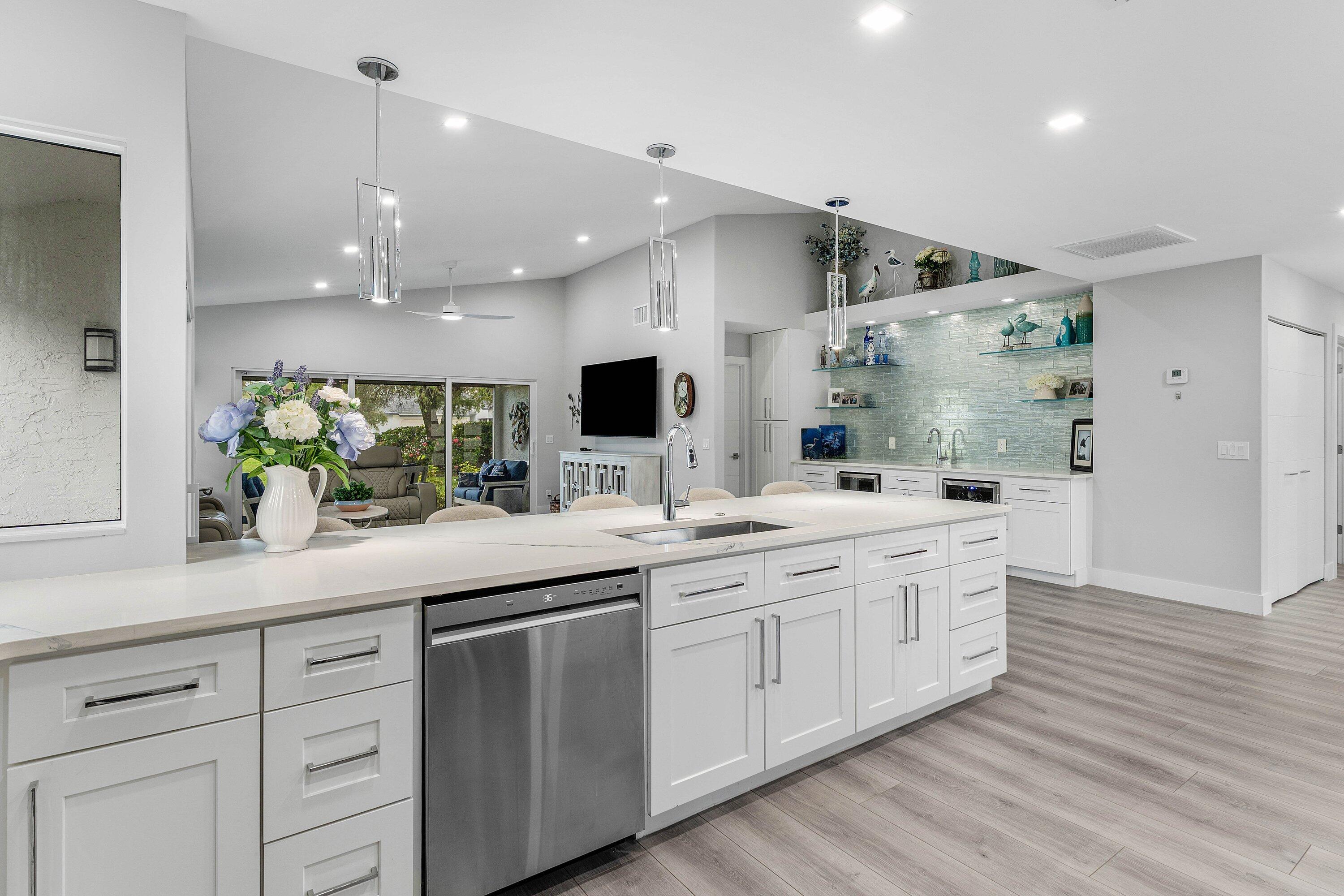 Built-in bar with glass shelving, tiled wall and two beverage refrigerators at 13320 Touchstone Court in Eastpointe
